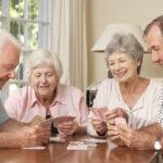 elderly people playing cards