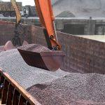 Crane,Lifting,Iron,Ore,From,The,Barge,At,Dindayal,Port