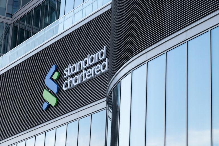 Standard Chartered shares up 14% on raised outlook