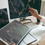 Investor,Man,Analyzing,The,Graph,Of,The,Stock,Market,Using