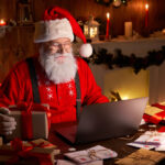 Happy,Old,Santa,Claus,Wearing,Hat,Holding,Gift,Box,Using