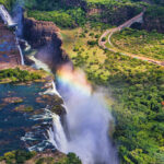 Rainbow,Over,Victoria,Falls,In,Zimbabwe,,Sunny,Day,In,Africa